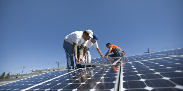 A group of men working on solar panelling