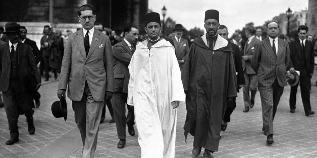 The Sultan of Morocco, Mohammed V wearing white robes, walking with the Grand Vizier, Si Mohammed El Mokri after he placed his wreath on the Tomb of the Unknown Warrior at the Arc De Triomphe during a visit to Paris, France around July 4, 1930. (AP Photo)