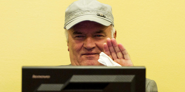 FILE - In this Friday, July 4, 2011, file photo former Bosnian Serb Gen. Ratko Mladic waves as he sits in the court room during his initial appearance at the U.N.'s Yugoslav war crimes tribunal in The Hague, Netherlands. UN prosecutors deliver their closing statement in the marathon genocide trial of former Bosnian Serb military chief Gen. Ratko Mladic, who is accused of commanding forces responsible for the worst atrocities of the Bosnian war. (AP Photo/ Valerie Kuypers, Pool, File)