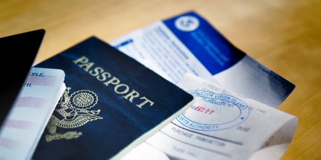 Two American passports with visa or tourist cards tucked inside all stamped and ready to go.g