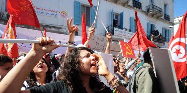 Tunisian workers from UGTT Tunisian General Labour Union shout slogans as they attend a May Day rally on May 1, 2014 in Tunis. AFP PHOTO / FETHI BELAID (Photo credit should read FETHI BELAID/AFP/Getty Images)