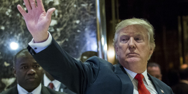 US President-elect Donald Trump waves to the crowd as he exits the elevators to speak with media at Trump Tower on December 6, 2016 in New York. / AFP / Eduardo Munoz Alvarez (Photo credit should read EDUARDO MUNOZ ALVAREZ/AFP/Getty Images)