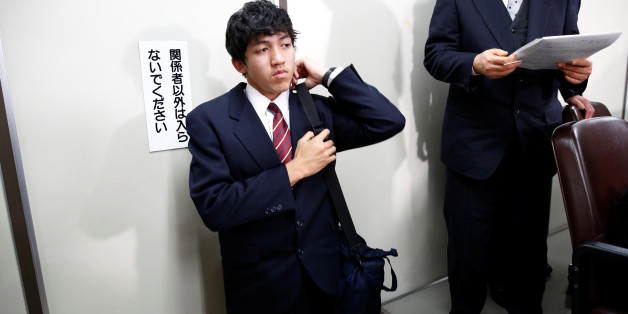 Utinan Won, a 16-year-old high school student living in Japan without a visa, holds his bag as he leaves from a news conference room in Tokyo, Japan, December 6, 2016. REUTERS/Kim Kyung-Hoon