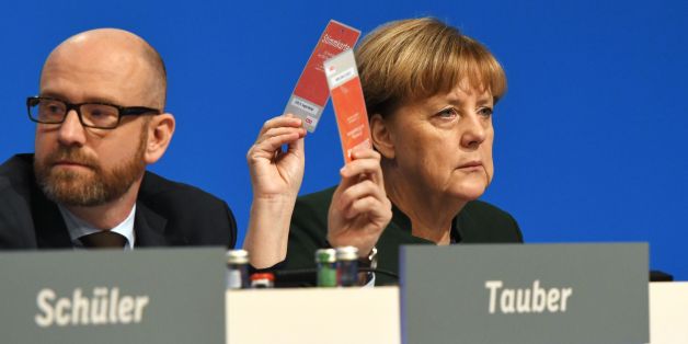 German Chancellor and Head of the Christian Democratic Union (CDU) Angela Merkel CDU Secretary General Peter Tauber vote during the party's congress in Essen, western Germany, on December 7, 2016.Party members gave Angela Merkel a standing ovation lasting more than 11 minutes but also dealt a blow in re-electing her as party chief with her worst score, 89.5 percent, since she became chancellor of Germany. / AFP / TOBIAS SCHWARZ (Photo credit should read TOBIAS SCHWARZ/AFP/Getty Images)