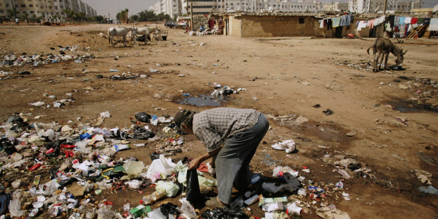 A man searches for food amongst garbage at Duar Skuila slum in Casablanca September 1, 2007. Hopelessness has the Casablanca shanty of Douar Escuela in its grip, Qadi Youssef said, and Friday's parliamentary election will do nothing to bring the jobs it desperately needs. Things have worsened since suicide bombings in March by young men from Douar Escuela, the same slum that was home to some of the Islamist militants who attacked Casablanca in 2003. Picture taken on September 1, 2007. To match