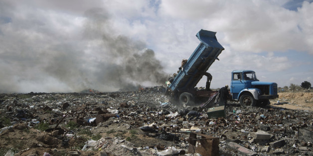 A truck empties into a dump on March 5, 2011 trash left by the thousands of foreign workers waiting to leave Libya and cross the border into Tunisia in Ras Djir, about 175 kms from Tripoli. Thousands of foreign workers desperate to flee deadly unrest in neighboring Libya have turned the airport of the Tunisian resort island of Djerba into another kind of gateway. The number of people fleeing Libya through Tunisia since February 20 has reached 100,000, according to regional Red Crescent representative Monji Slim. AFP PHOTO / JOEL SAGET (Photo credit should read JOEL SAGET/AFP/Getty Images)