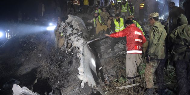 Pakistani soldiers and volunteers search for victims from the wreckage of the crashed PIA passenger plane Flight PK661 at the site in the village of Saddha Batolni in the Abbottabad district of Khyber Pakhtunkhwa province on December 7, 2016.A Pakistani plane carrying 48 people crashed on December 7, in the country's mountainous north and burst into flames killing everyone on board, authorities said, in one of the deadliest aviation accidents in the country's history. Pakistan International Airl