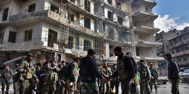 Syrian government troops gather as they patrol the al-Shaar neighbourhood after taking control of the area in the eastern part of the northern city of Aleppo on December 7, 2016.Rebels in Aleppo called for a five-day truce and the evacuation of civilians after losing more than three quarters of their territory including the Old City to a Syrian army offensive. / AFP / GEORGE OURFALIAN (Photo credit should read GEORGE OURFALIAN/AFP/Getty Images)