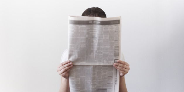 Woman looking at newspaper