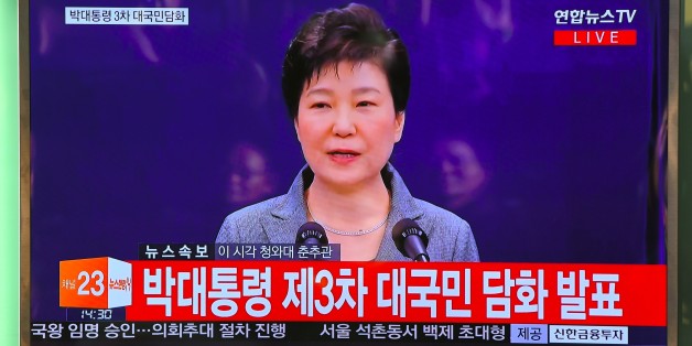 People watch a television news live showing South Korean President Park Geun-Hye making a speech, at a railway station in Seoul on November 29, 2016.South Korea's scandal-hit President Park Geun-Hye said on November 29 she was willing to leave office before the end of her official term early 2018 and would let parliament decide on her fate. / AFP / JUNG Yeon-Je (Photo credit should read JUNG YEON-JE/AFP/Getty Images)