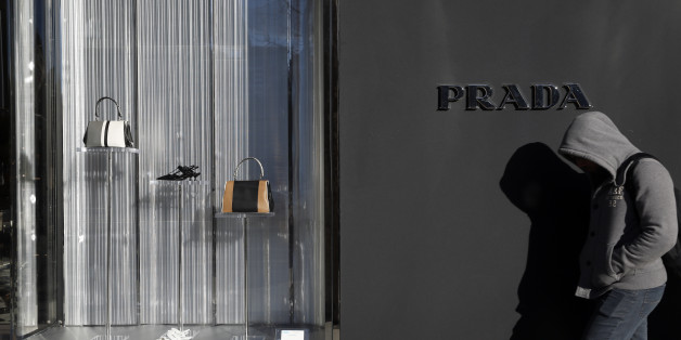 A man walks past a Prada store in Madrid, Spain, March 10, 2016. REUTERS/Susana Vera