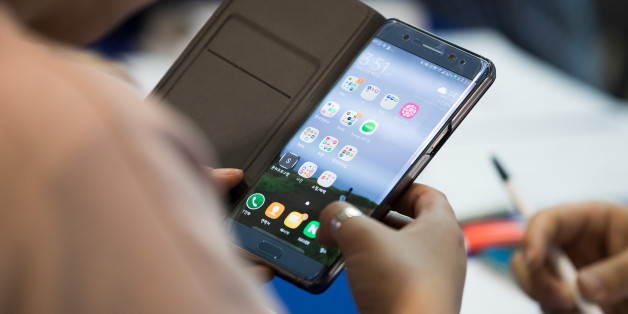 A woman checks her Samsung Electronics Co. Galaxy Note 7 smartphone at a Samsung kiosk providing rental phones for users of the Note 7 at Incheon International Airport in Incheon, South Korea, on Tuesday, Oct. 25, 2016. In what may be the first Note 7 related class-action lawsuit filed in South Korea, 527 smartphone buyers are demanding Samsung Electronics Co. pay each plaintiff about 500,000 won (about $440) for time and effort lost when the phones were first recalled and then scrapped amid rep