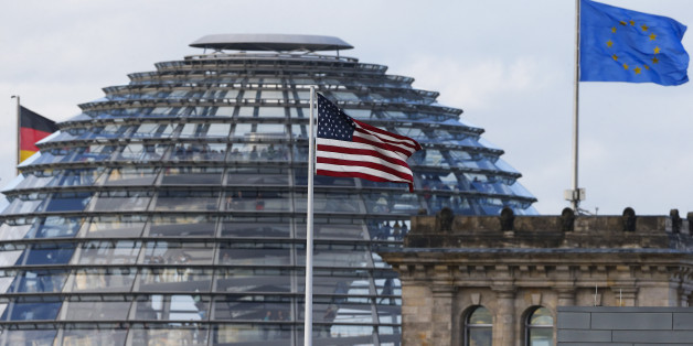 The flag on the U.S. embassy is pictured next to the Reichstag building, seat of the German lower house of parliament Bundestag, in Berlin October 28, 2013. A German newspaper said on Sunday that U.S. President Barack Obama knew his intelligence service was eavesdropping on Angela Merkel as long ago as 2010, contradicting reports that he had told the German leader he did not know REUTERS/Tobias Schwarz (GERMANY - Tags: POLITICS CITYSCAPE)