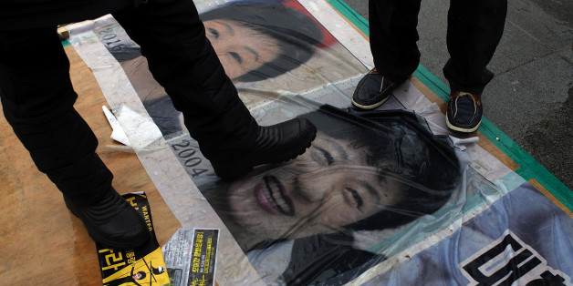 SEOUL, SOUTH KOREA - NOVEMBER 26: People gathered for a rally against South Korean President Park Geun-hye and step on the Park Geun-hye's portraits on November 26, 2016 in Seoul, South Korea. Park has recorded worst ever polling figures for the country's presidency after her friend Choi Soon-sil was charged with corrupt influence over state affairs. (Photo by Woohae Cho/Getty Images)