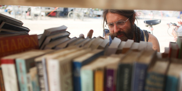 Dario Clocchiatti looks for a book at one of the temporary libraries on the "Playa" as approximately 70,000 people from all over the world gather for the 30th annual Burning Man arts and music festival in the Black Rock Desert of Nevada, U.S. September 3, 2016. REUTERS/Jim Urquhart FOR USE WITH BURNING MAN RELATED REPORTING ONLY. FOR EDITORIAL USE ONLY. NOT FOR SALE FOR MARKETING OR ADVERTISING CAMPAIGNS. NO THIRD PARTY SALES. NOT FOR USE BY REUTERS THIRD PARTY DISTRIBUTORS