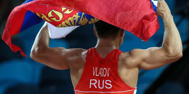 RIO DE JANEIRO, BRAZIL - AUGUST 14, 2016: Russia's Roman Vlasov waving his national flag after winning the men's -75kg wrestling final against Mark Overgaard Madsen of Denmark at the Rio 2016 Summer Olympic Games, at Carioca Arena 2. Valery Sharifulin/TASS (Photo by Valery Sharifulin\TASS via Getty Images)