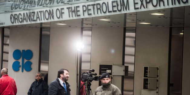 An OPEC logo sits on the wall as security and media stand outside of the OPEC Secretariat ahead of the 171st Organization of Petroleum Exporting Countries (OPEC) meeting in Vienna, Austria, on Tuesday, Nov. 29, 2016. An OPEC deal to curtail oil production appeared in jeopardy as Iran said it wont make cuts while Saudi Arabia insisted Tehran must be willing to play a meaningful role in any agreement. Photographer: Akos Stiller/Bloomberg via Getty Images