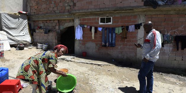 A Sub-Saharan woman does some washing-up at the bottom of a makeshift building, where she lives with other fellow migrants in impoverished conditions, on May 29, 2016, in the capital Algiers. In the past, Algeria was a land of emigration, millions of its citizens exiled to France, but in recent years it has become a destination country for many West Africans. Nigerians, Malians, Cameroonians, brave the horrors of the Sahara to find refuge in the largest country in Africa, as the crossing to Eur