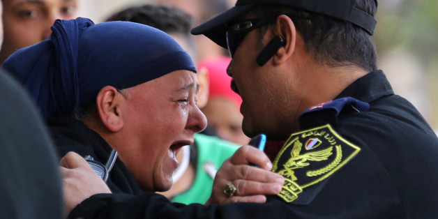 A relative of one of the blast victims screams at a police officer in front of St. Mark's Coptic Orthodox Cathedral after an explosion inside the cathedral in Cairo, Egypt December 11, 2016. REUTERS/Mohamed Abd El Ghany TPX IMAGES OF THE DAY