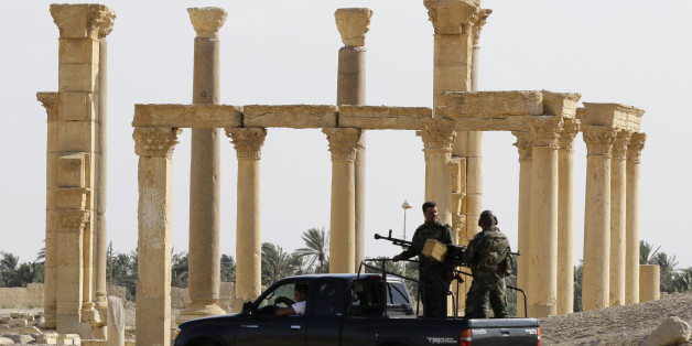 Members of the Syrian army patrol as people visit the the ancient Syrian city of Palmyra on May 6, 2016, during a patriotic celebration put on by the Syrian regime at the UNESCO world heritage site, with flag-waving and military music in a place where just last year jihadists carried out mass executions.Syrian troops backed by Russian air strikes and special forces on the ground recaptured the UNESCO world heritage site from Islamic State group fighters in March. / AFP / LOUAI BESHARA (Ph