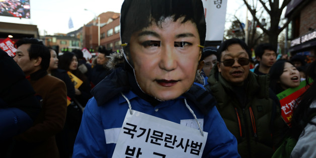 SEOUL, SOUTH KOREA - DECEMBER 10: Protesters wearing masks of South Korea's President Park Geun-Hye during a rally against South Korean President Park Geun-Hye on December 10, 2016 in Seoul, South Korea. The South Korean National Assembly voted yesterday for an impeachment motion at its plenary session, which will set up the rare impeachment trial for President Park over the accusation of corruption involving Park and her long time confidante. (Photo by Chung Sung-Jun/Getty Images)