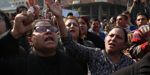 CAIRO, EGYPT - DECEMBER 12: People react during the funeral ceremony for the victims of the explosion at Saint Peter and Saint Paul Coptic Orthodox Church in Abbasiya district, at Church of the Virgin Mary in Nasr City neighborhood of Cairo, Egypt on December 12, 2016. (Photo by Ahmed Gamil/Anadolu Agency/Getty Images)