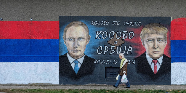A woman walks past a mural of U.S. president-elect Donald Trump and Russian President Vladimir Putin in Belgrade, Serbia, December 4, 2016. The text on the mural reads in Russian, Serbia and English "Kosovo is Serbia". REUTERS/Marko Djurica