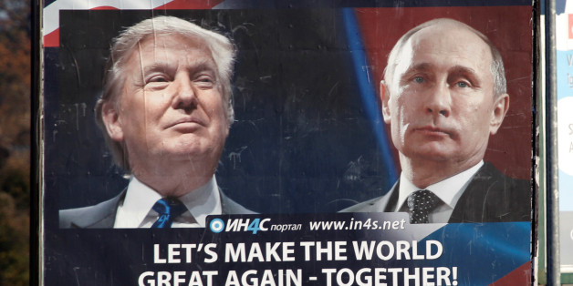 Pedestrians cross the street behind a billboard showing a pictures of US president-elect Donald Trump and Russian President Vladimir Putin in Danilovgrad, Montenegro, November 16. 2016. REUTERS/Stevo Vasiljevic