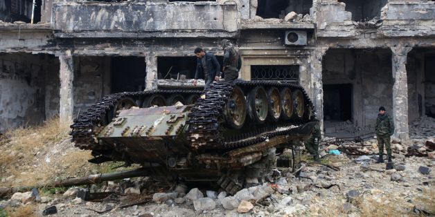Syrian pro-government forces stand on a tank near the ancient Umayyad mosque in the old city of Aleppo on December 13, 2016, after they captured the area.
After weeks of heavy fighting, regime forces were poised to take full control of Aleppo, dealing the biggest blow to Syria's rebellion in more than five years of civil war.
/ AFP / Youssef KARWASHAN (Photo credit should read YOUSSEF KARWASHAN/AFP/Getty Images)