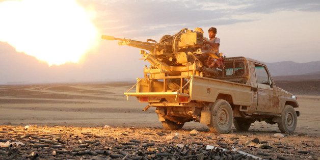 A Yemeni tribesman from the Popular Resistance Committees, supporting forces loyal to Yemen's Saudi-backed President Abedrabbo Mansour Hadi, fires a machine gun in the area of Sirwa, west of the city of Marib, some 170 kilometres (105 miles) east of the capital Sanaa on December 14, 2015. AFP PHOTO / ABDULLAH AL-QADRY / AFP / ABDULLAH AL-QADRY (Photo credit should read ABDULLAH AL-QADRY/AFP/Getty Images)