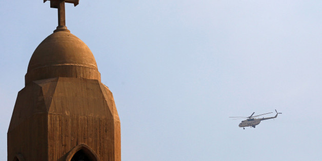 A military helicopter flies above the Virgin Mary church during the funeral for victims killed in the bombing of Cairo's main Coptic cathedral, in Cairo, Egypt December 12, 2016. REUTERS/Amr Abdallah Dalsh