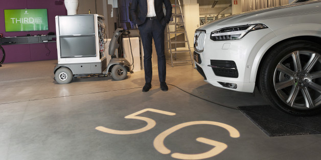 Hans Vestberg, chief executive officer of Ericsson AB, poses for a photograph beside a 5G base station prototype, left, and a Volvo Cars XC90 automobile, following an earnings news conference in Kista, Sweden, on Friday, Oct. 23, 2015. Ericsson AB reported third-quarter profitability and sales that missed analysts' estimates as business in Japan, Russia and Brazil slumped and spending slowed in China on fourth-generation networks that power smartphones and tablets. Photographer: Johan Jeppsson/B