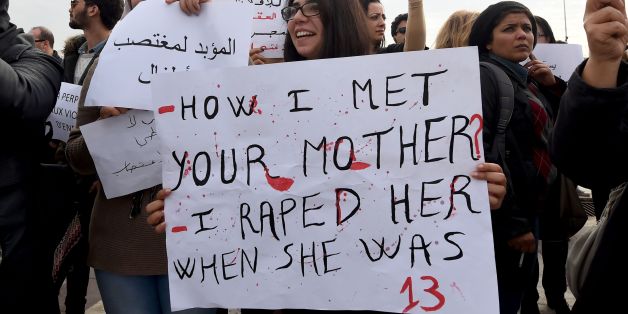 Tunisian women hold placards during a demonstration against the article 227 bis of the penal code on December 14, 2016, outside the Assembly of the Representatives of the People in Tunis, after a Tunisian court has approved the marriage of a 13-year-old girl to a relative who made her pregnant.
Under Tunisian law, sex with a girl under 15 without the use of force is punishable by six years in prison, but the culprit can halt proceedings by marrying the victim.
/ AFP / FETHI BELAID (Photo credit should read FETHI BELAID/AFP/Getty Images)