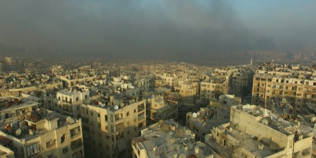 A still image from video taken December 12, 2016 of a general view of smoke rising over bomb damaged eastern Aleppo, Syria. Video released December 12, 2016. REUTERS/via ReutersTV
