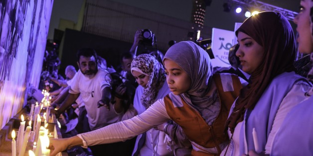 CAIRO, EGYPT - MAY 26: EgyptAir employees and relatives of the victims light candles during the commemoration march for 66 victims of EgyptAir flight MS804 crash in front of Opera Building in Cairo, Egypt on May 26, 2016. (Photo by Ibrahim Ramadan/Anadolu Agency/Getty Images)