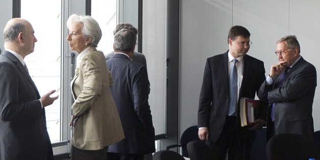 (L-R) European Commissioner for Economic and Financial Affairs, Taxation and Customs Pierre Moscovici speaks with Managing Director of the International Monetary Fund Christine Lagarde as Latvian Prime Minister and European Commissioner for the Euro and Social Dialogue Valdis Dombrovski speaks with Managing Director of the European Stability Mechanism (ESM) Klaus Regling at the start of a meeting on Greece at the European Commission in Brussels on June 24, 2015. Greek Prime Minister Alexis Tsipras was summoned to Brussels for a decisive meeting with key EU-IMF creditors on June 24 as eurozone finance ministers try to finalise a debt deal and avoid a default by Athens. AFP PHOTO / POOL / VIRGINIA MAYO (Photo credit should read VIRGINIA MAYO/AFP/Getty Images)