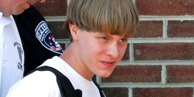 Police lead suspected shooter Dylann Roof into the courthouse in Shelby, North Carolina, U.S. June 18, 2015. REUTERS/Jason Miczek/File Photo