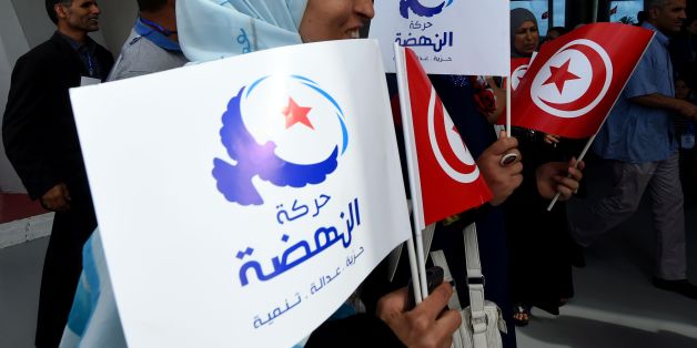 Supporters of Tunisia's Islamist Ennahdha Party wave the national and party flags on May 20, 2016 during the opening of Ennahdha's three-day congress in Tunis.
Thousands of people attended the opening ceremony of the congress -- the first since 2012 -- held at a sports complex in Rades, south of the capital Tunis, amid heavy police security. / AFP / FETHI BELAID (Photo credit should read FETHI BELAID/AFP/Getty Images)