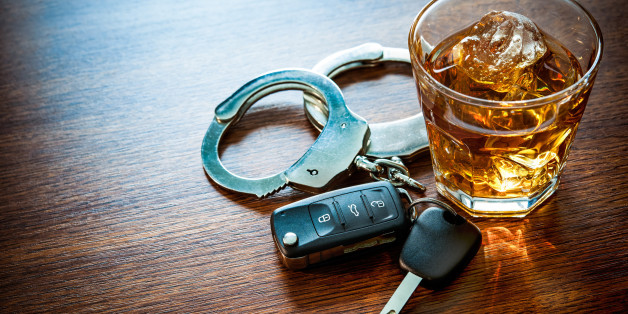 Whiskey with car keys and handcuffs concept for drinking and driving