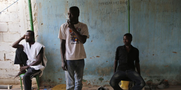 African migrants are seen at their temporary accommodation in Ghat, southwest Libya near the border with Algeria May 29, 2014. Many migrants search for work in Ghat to save money to pay for their onward journey. Libya's southwestern tip in the Sahara bordering Algeria and Niger has turned into an open door for illegal migrants from sub-Saharan countries heading for Europe, with the chaotic government in Tripoli appearing to have abandoned all control. The revolt that overthrew Libyan leader Muam