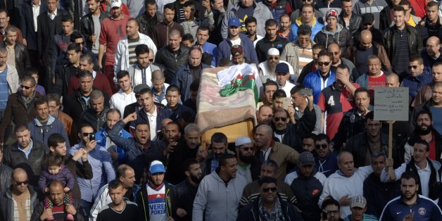 Relatives and friends carry the body of British-Algerian journalist Mohamed Tamalt as mourners walk towards the cemetery during his funeral, on December 12, 2016 in Algiers.Mohamed Tamalt died on December 11, 2016 after having staged a hunger strike to protest a two-year jail term for offending Algeria's president in a poem posted online, his lawyer said. / AFP / RYAD KRAMDI (Photo credit should read RYAD KRAMDI/AFP/Getty Images)