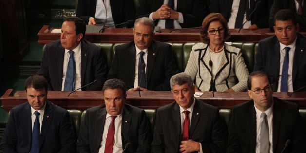 (Front row from L-R) Tunisia's Interior Minister Hedi Majdoud, Defence Minister Farhat Horchani, Justice Minister, Ghazi Jribi and premier-designate Youssef Chahed, (back row from L-R) Foreign Minister Hematines Jhinaoui, Minister of Religious Affairs Abdeljalil Ben Salem, Minister of Finance Lamia Zribi and Minister to the Head of State for Parliament Relations Iyad Dahmani attend a parliamentary session to present his Chahed's governement at the parliament in Tunis on August 26, 2016. It is li