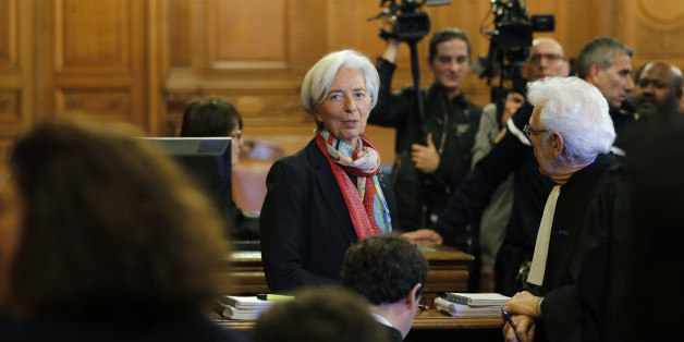 Managing Director of the International Monetary Fund (IMF) Christine Lagarde (R) talks with her lawyer Bernard Grelon before the start of her trial about a state payout in 2008 to a French businessman, at the courts in Paris, France, December 12, 2016. REUTERS/Philippe Wojazer