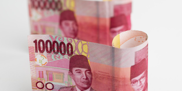Indonesian 100,000 rupiah banknotes are arranged for a photograph in Bangkok, Thailand, on Tuesday, Sept. 15, 2015. Indonesia is preparing a major overhaul of financial safety regulations to guard against the potential for bank collapses. Indonesian banks are facing slower loan growth and a weakening economy at a time when the Federal Reserve is preparing to lift U.S. interest rates, a move that has the potential to create more disruption in emerging markets. Photographer: Brent Lewin/Bloomberg