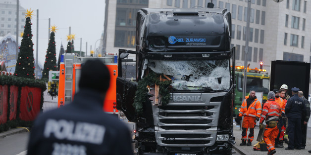 Police stand in front of the truck which ploughed last night into a crowded Christmas market in the German capital Berlin, Germany, December 20, 2016. REUTERS/Hannibal Hanschke