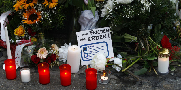 BERLIN, GERMANY - DECEMBER 20: A message reading freedom on Earth lays between flowers at the area after a lorry truck ploughed through a Christmas market on December 20, 2016 in Berlin, Germany. So far 12 people are confirmed dead and 45 injured. Authorities have confirmed they believe the incident was an attack and have arrested a Pakistani man who they believe was the driver of the truck and who had fled immediately after the attack. Among the dead are a Polish man who was found on the passe