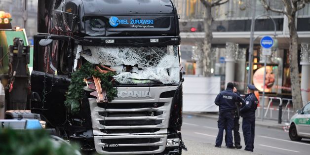 Policemen stand next to a truck on December 20, 2016 at the scene where it crashed into a Christmas market near the Kaiser-Wilhelm-Gedaechtniskirche (Kaiser Wilhelm Memorial Church) in Berlin.German police said they were treating as 'a probable terrorist attack' the killing of 12 people when the speeding lorry cut a bloody swath through the packed Berlin Christmas market. / AFP / Tobias SCHWARZ (Photo credit should read TOBIAS SCHWARZ/AFP/Getty Images)