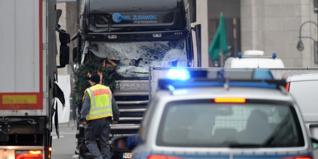 BERLIN, GERMANY - DECEMBER 20: Security and rescue workers work at the scene after a truck crashed into a crowded Christmas market in Berlin, Germany on December 20, 2016. German police said they are investigating the death of at least 12 people and nearly 50 injuries when a truck crashed into a crowded Christmas market late Monday as a probable terrorist attack. (Photo by Maurizio Gambarini/Anadolu Agency/Getty Images)