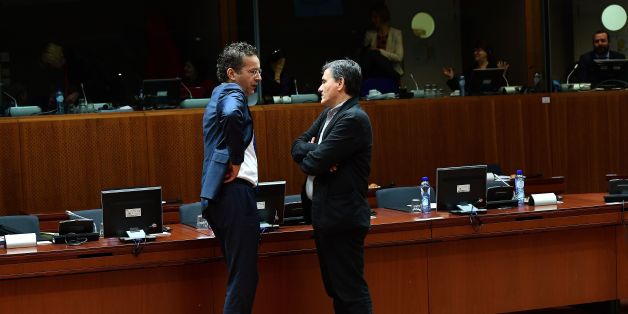 Eurogroup President and Dutch Finance Minister Jeroen Dijsselbloem (L) speaks with Greece's Finance Minister Euclid Tsakalotos during an Economic and Financial (ECOFIN) Affairs Council meeting at the European Council, in Brussels, on December 6, 2016. / AFP / EMMANUEL DUNAND (Photo credit should read EMMANUEL DUNAND/AFP/Getty Images)