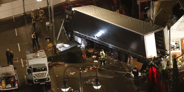 Authorites inspect a truck that had sped into a Christmas market in Berlin, on December 19, 2016, killing at least nine people and injuring dozens more.
Ambulances and heavily armed officers rushed to the area after the driver drove up the pavement of the market in a square popular with tourists, in scenes reminiscent of the deadly truck attack in the French city of Nice last July. / AFP / Odd ANDERSEN (Photo credit should read ODD ANDERSEN/AFP/Getty Images)